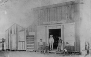 People sitting and standing outside the Pearce post office in 1896
