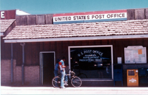 Pedestrian and bicyclist outside United States Post Office Agua Fria Rural Branch Prescott, AZ