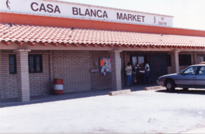 Casa Blanca Market, which houses the Bapchule post office; people coming and going through the door