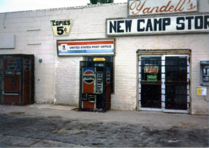 White building with multiple Pepsi vending machines outside and signage Yandell's New Camp Store and United States Post Office