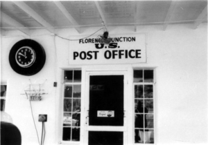 Exterior building with a clock and signage Florence Junction U.S. Post Office, Pepsi