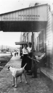 People and dog outside Humboldt store that sells magazines ,newspapers, and stationery