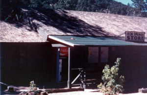 Cabin exterior porch, Coca Cola machine, and Iron Springs Store signage
